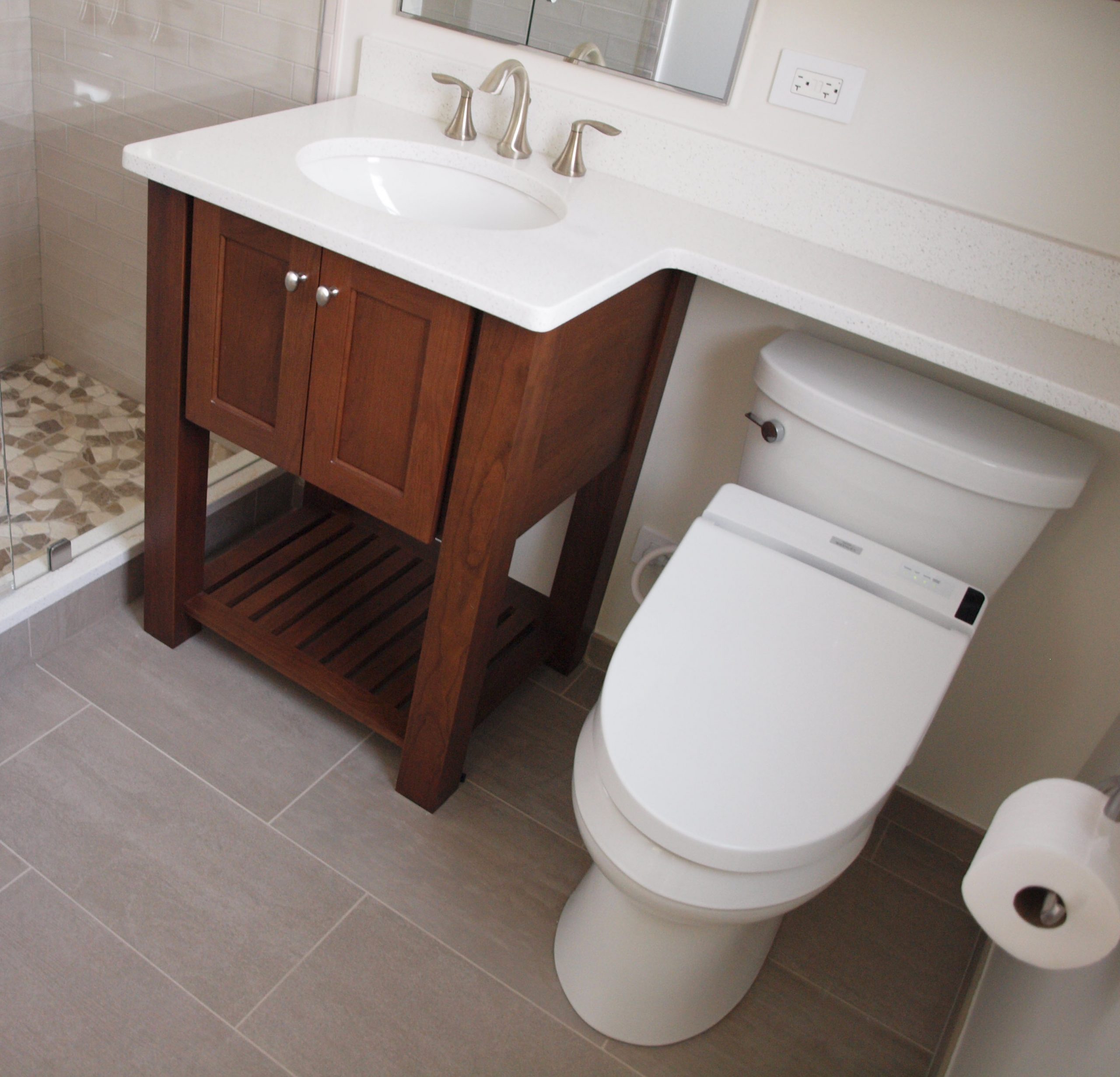 Wood bathroom vanity, bidet toilet and banjo countertop in a small bathroom