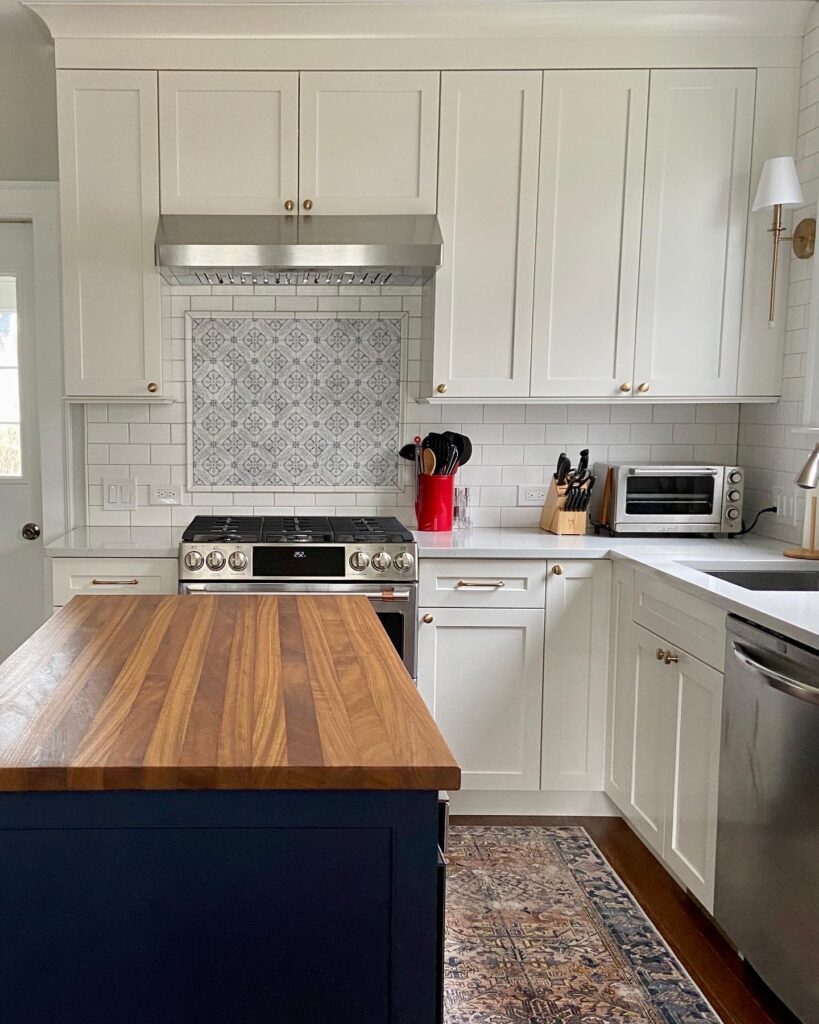 navy island with butcher block countertop in white kitchen 