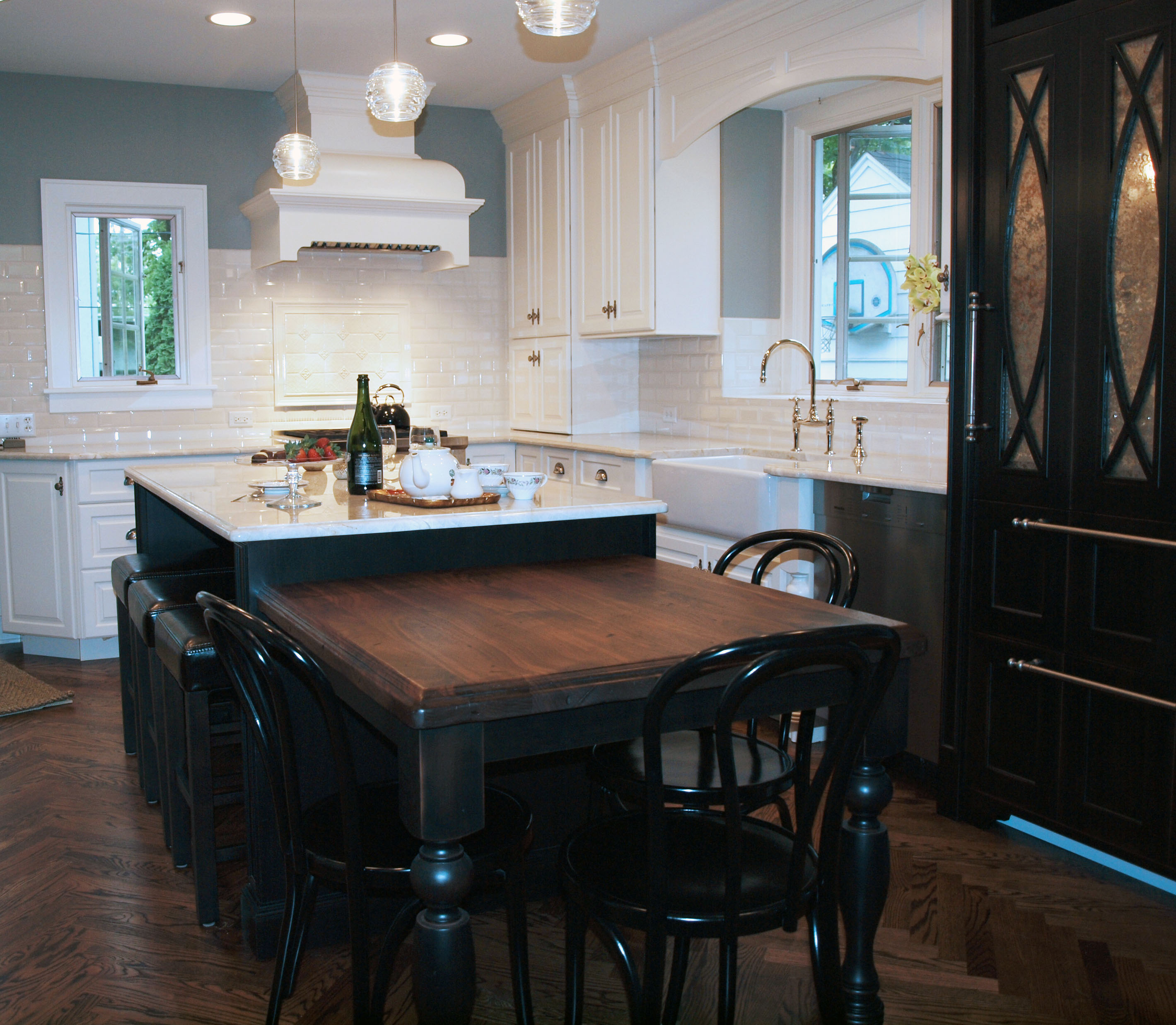 Kitchen with two level island that mixes wood and stone