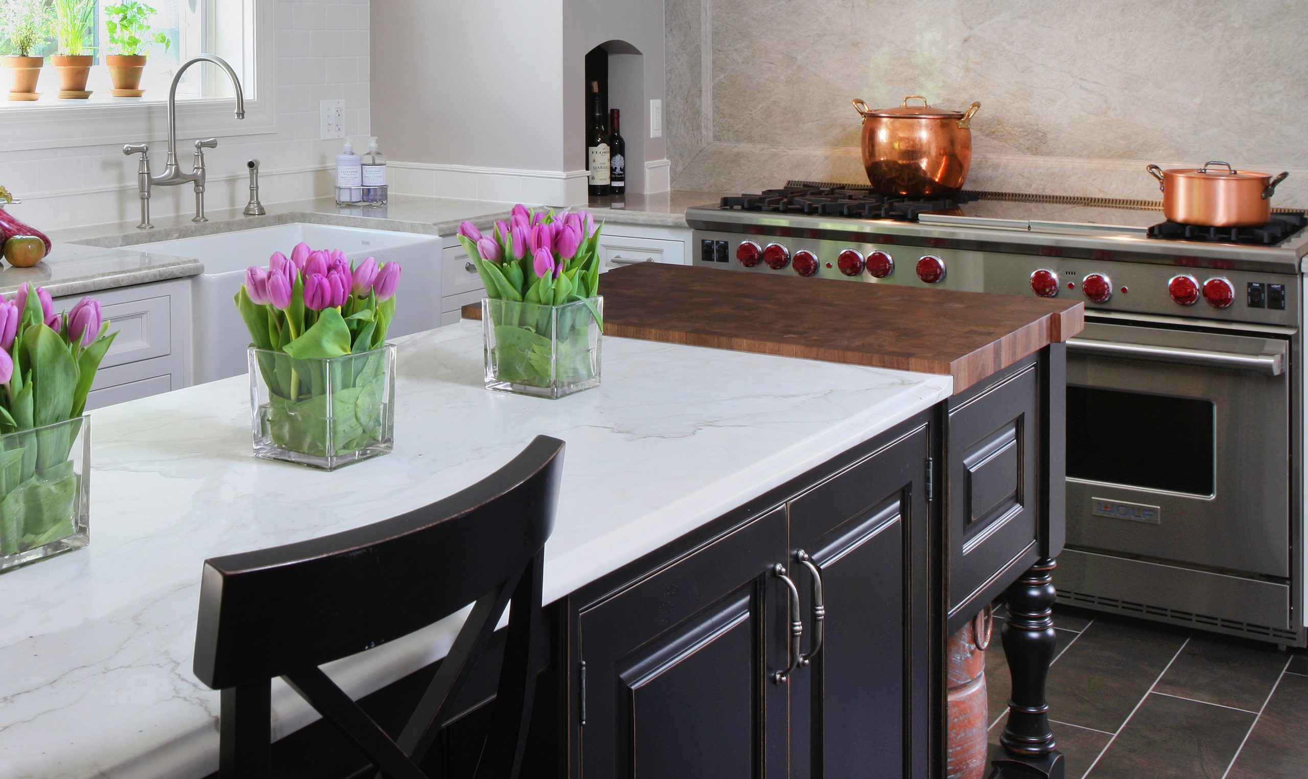 Kitchen island with butcher block and marble countertops