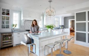 woman in white kitchen with her pet cat