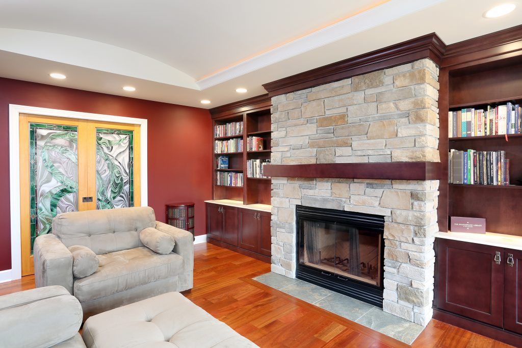 stone fireplace wall with rustic mantle