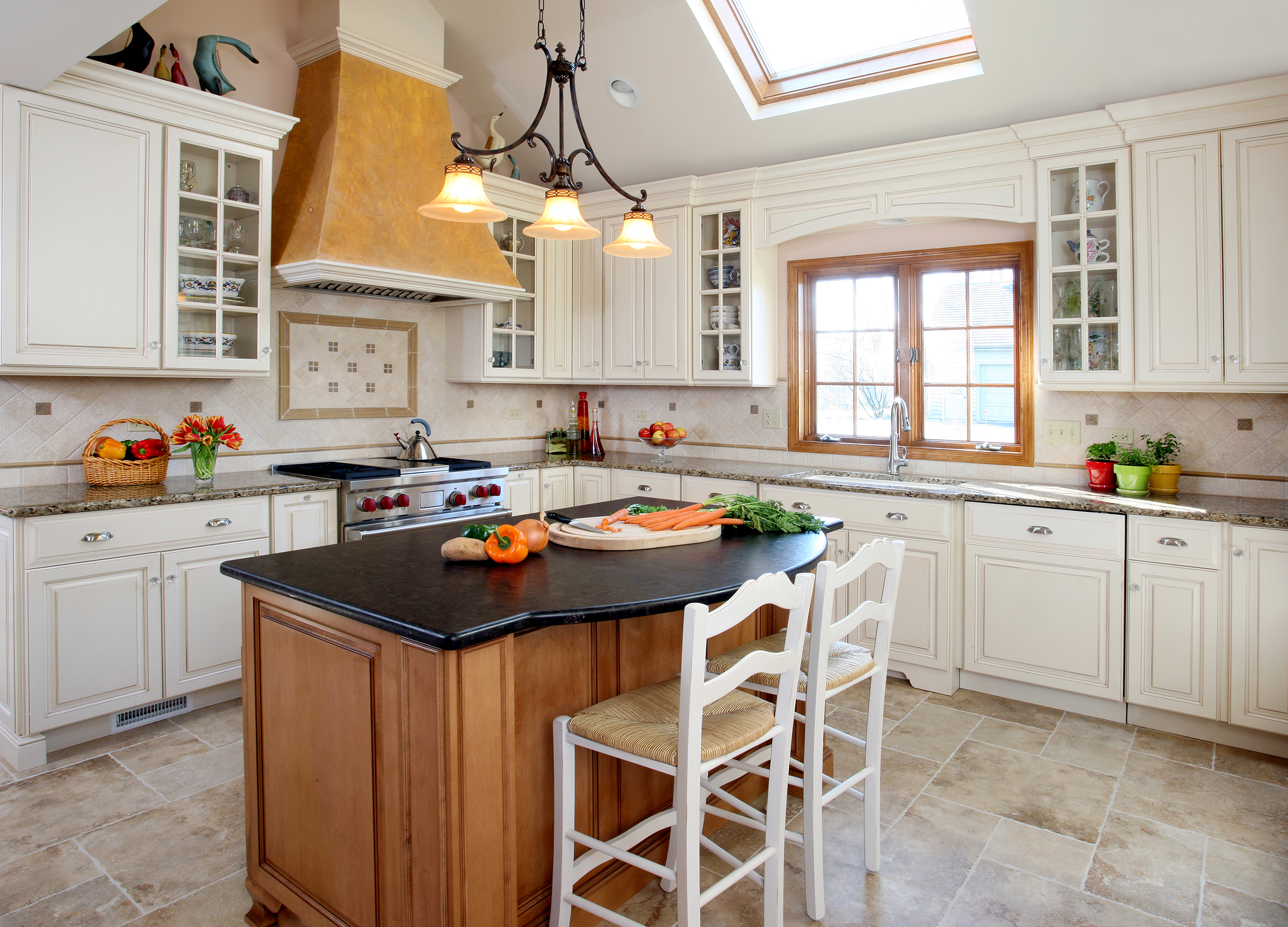 Painted cream cabinets with stained island and stained window trim