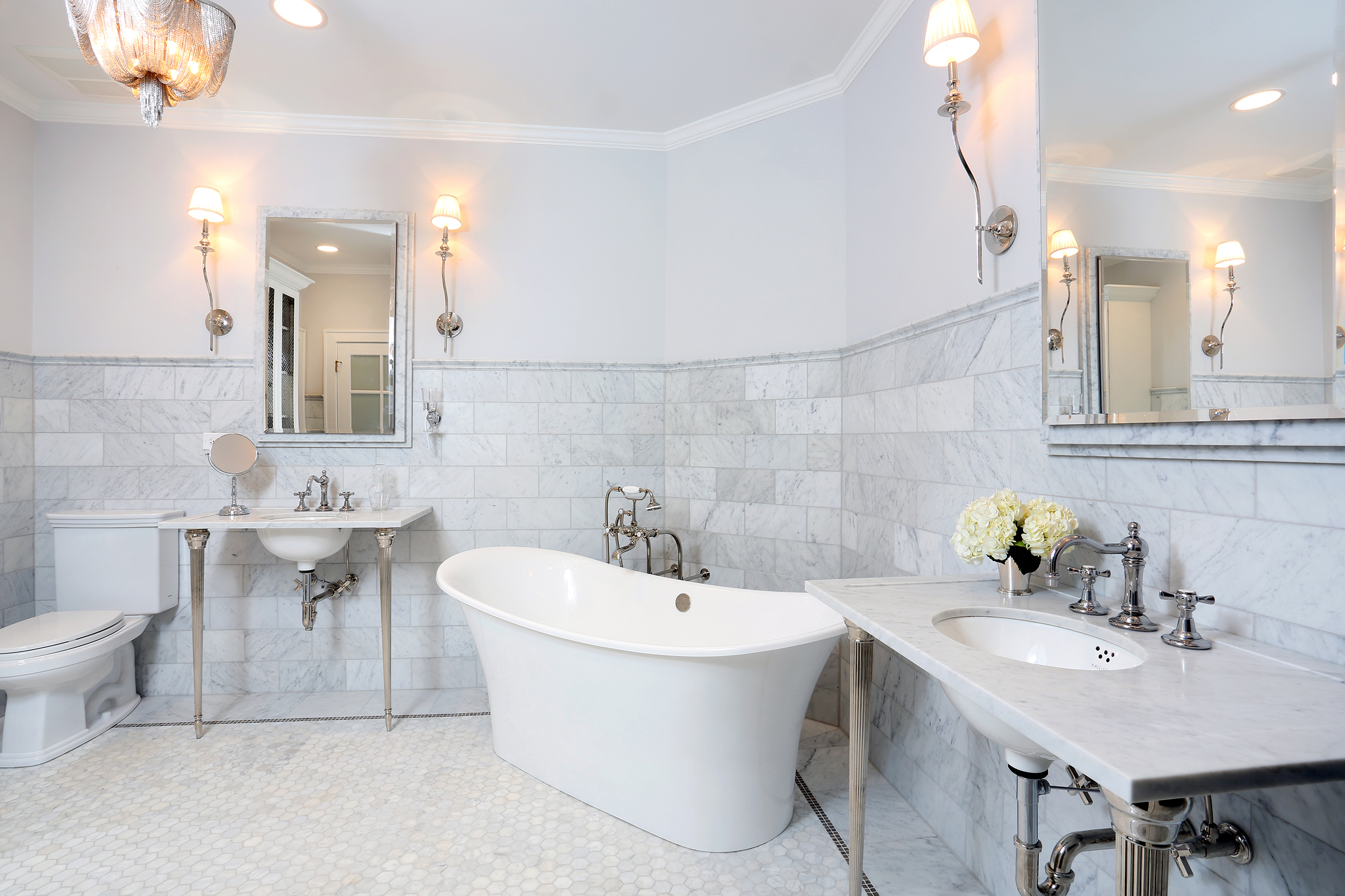 Master bathroom with console sinks and freestanding tub