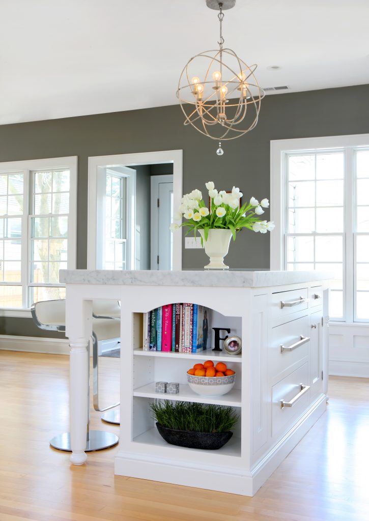 book shelves at the end of a kitchen island