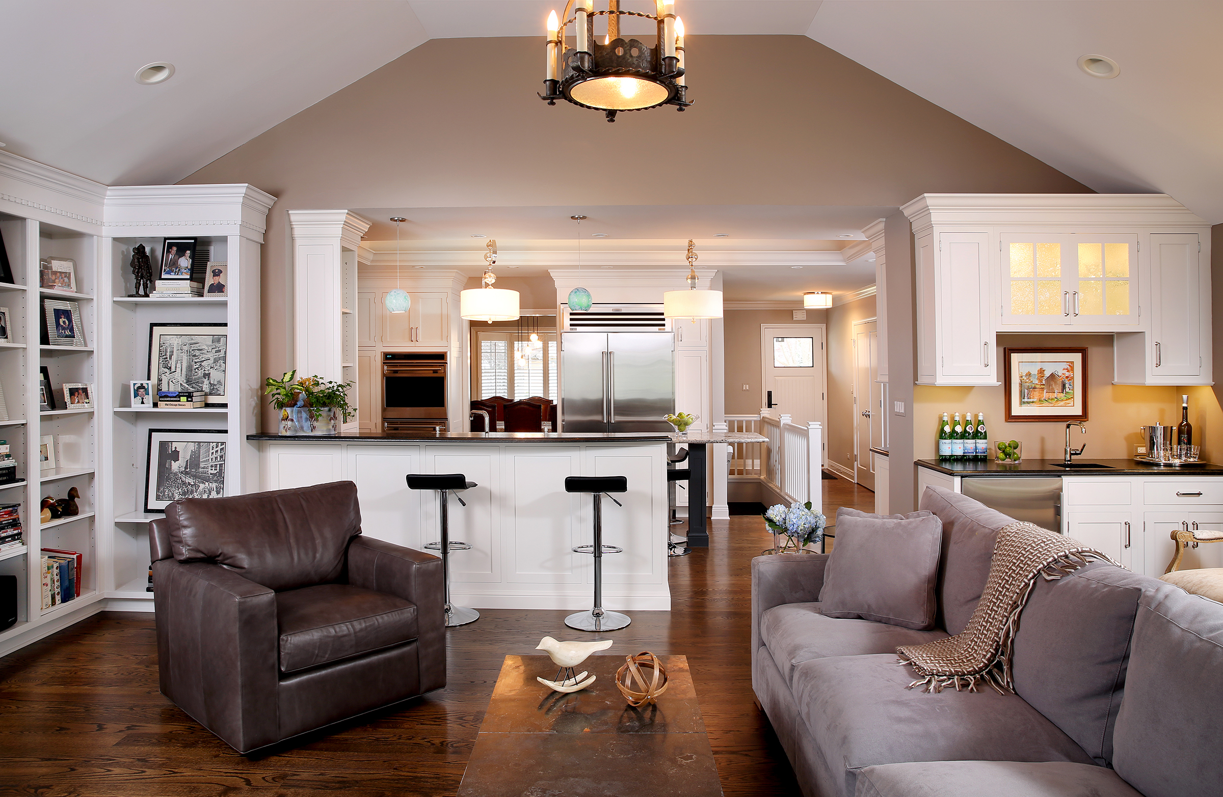 Family room with vaulted ceiling open to adjoining kitchen