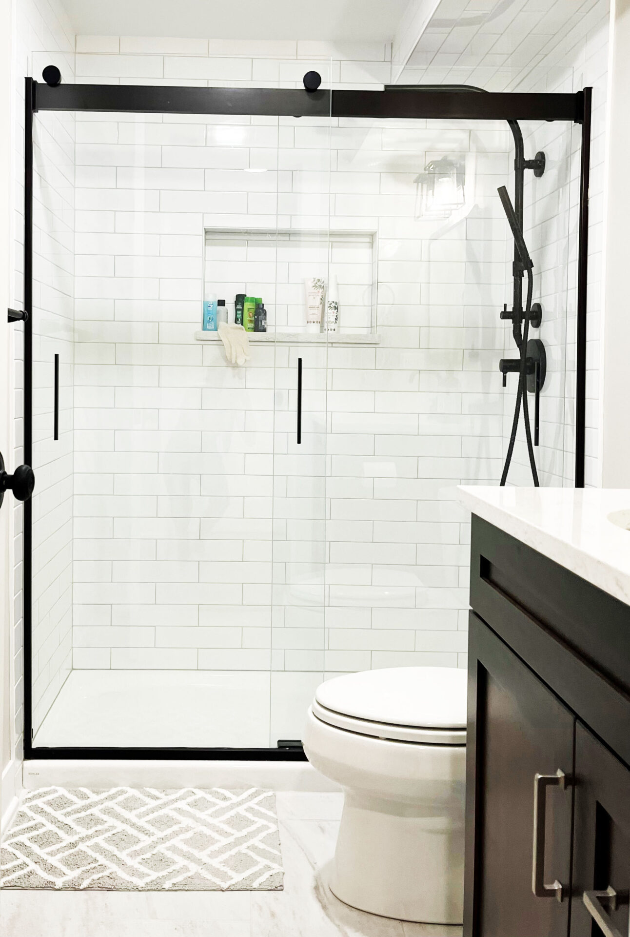 basement bathroom with framed shower and black fixtures