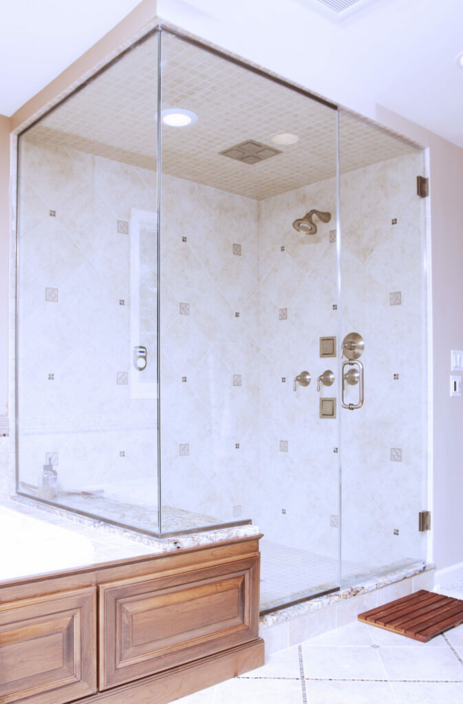 Semi-frameless shower enclosure