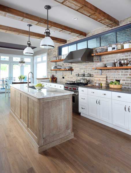 eclectic kitchen with brick backsplash and a distressed island