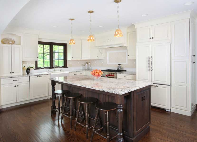 White kitchen cabinets with stained island and stained window trim