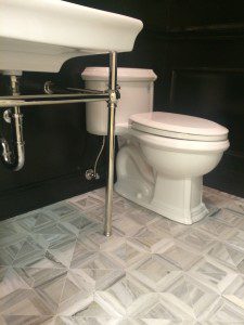 stone mosaic flooring in powder room