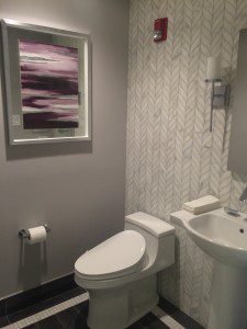 powder room with stone mosaic accent wall