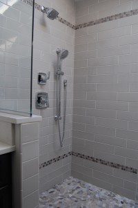 shower with pebble tile floor