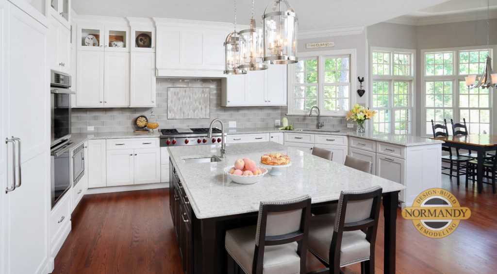 u-shaped white traditional kitchen with dark stained eat-in island