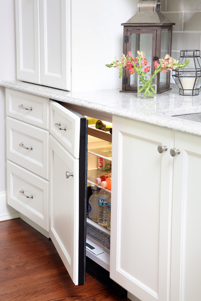 small refrigerator hidden with cabinet front