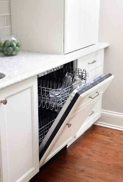 Dishwasher hidden behind cabinetry panel