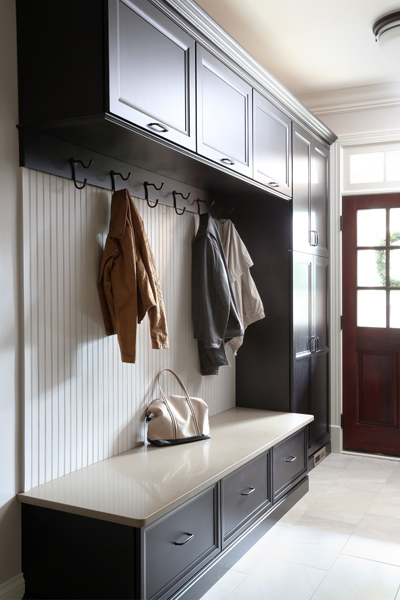 Mudroom space with cabinets and hooks for jackets