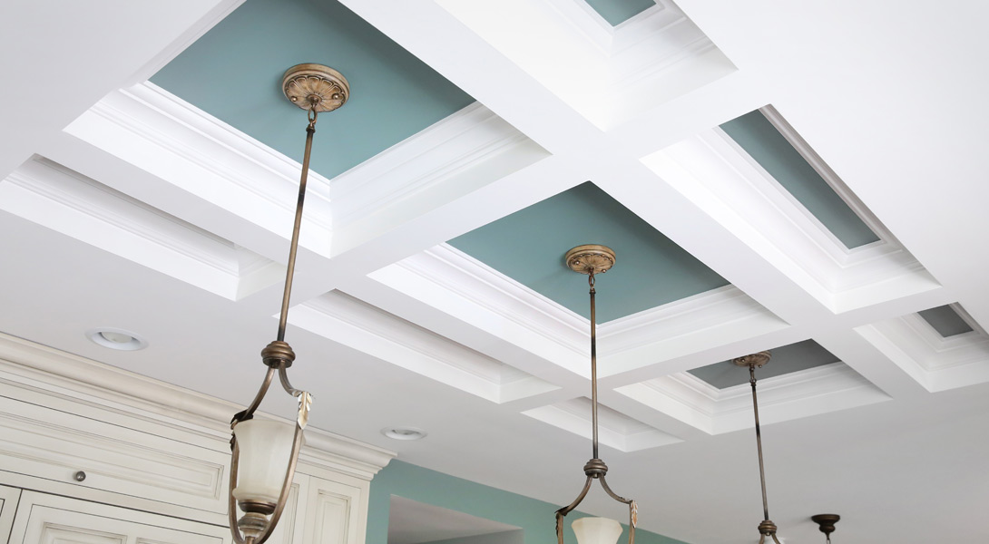 coffered ceiling beams with blue paint and pendant lights