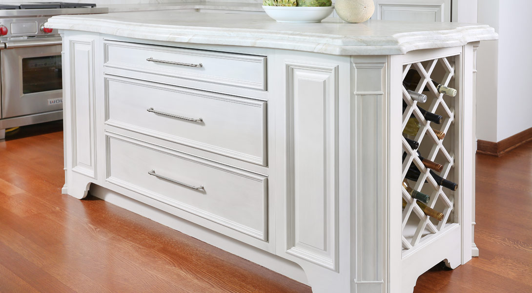 wine storage in the island of white painted kitchen