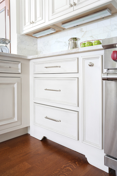 cabinet with trio of drawers with a custom spice pull out