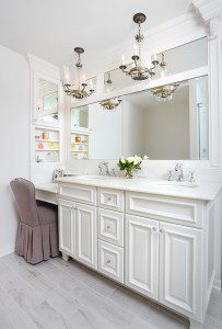 Master bathroom vanity with makeup table, chandeliers and divided mirrors