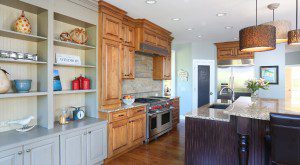 Kitchen with light and dark stained cabinets and adjoining painted cabinets