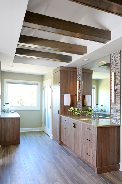 spa inspired master bathroom with ceiling beams and ample storage