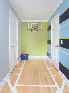 Kids bedroom with colorful paint and floor designed to look like a basketball freethrow line