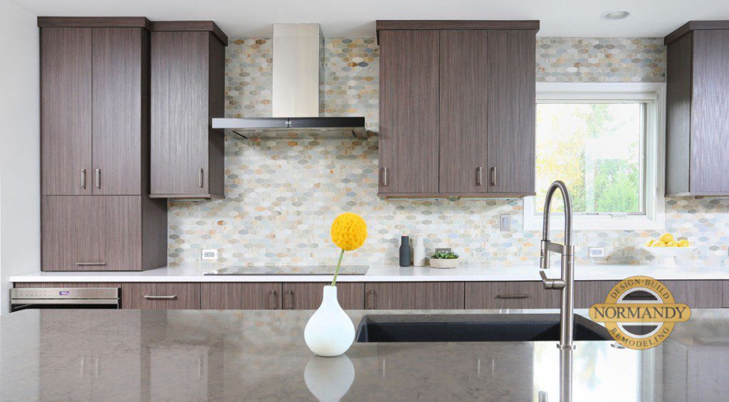 Flat panel cabinet fronts and a straight line metal hood create a contemporary look for htis kitchen