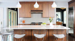 Flat panel cabinets in a medium wood tone stain and a contrasting light colored countertop