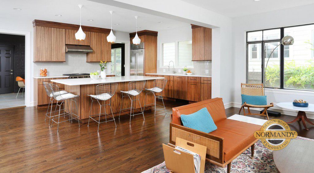 open floorplan kitchen with stained cabinetry in medium wood tones