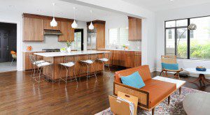 open floorplan kitchen with stained cabinetry in medium wood tones