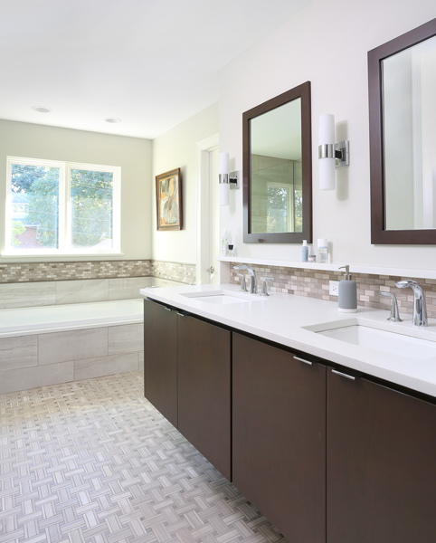 master bathroom vanity with two sinks and bathtub with tub deck