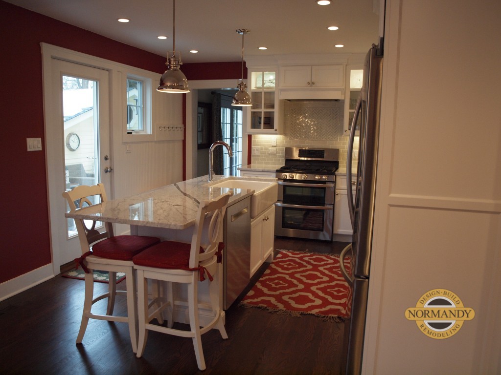 narrow kitchen remodel with white cabinets and island