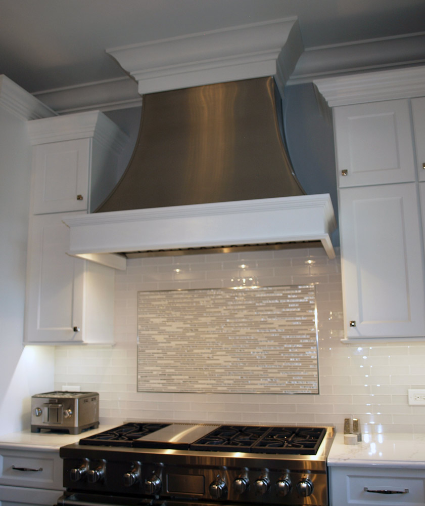 Custom metal range hood with wood trim