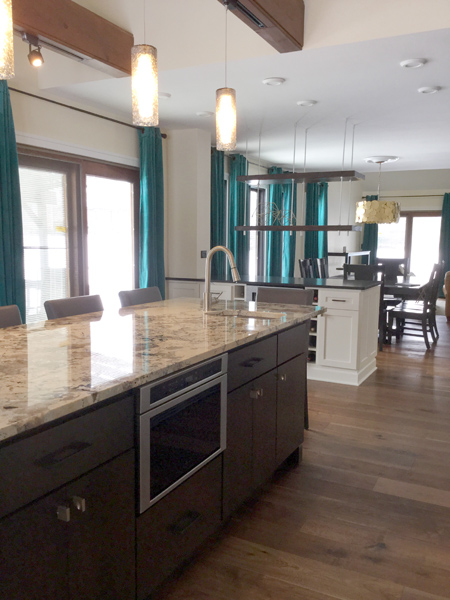 Suspended shelves separate kitchen from dining room