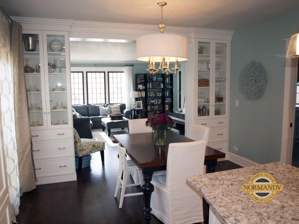 Dining area open to living space framed by cabinets