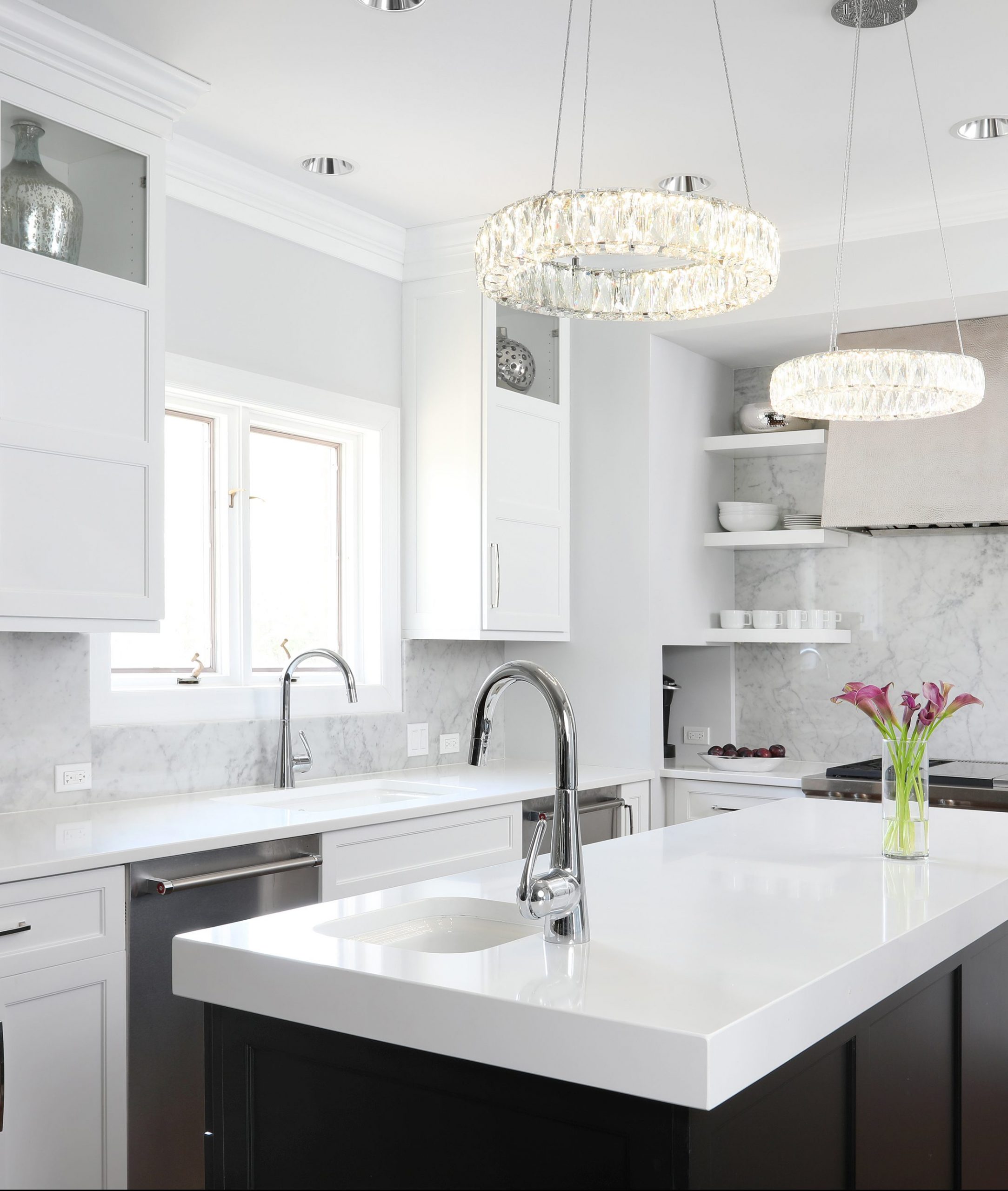 White kitchen with island and metal range hood