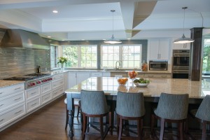 White kitchen with large windows near sink for natural light.