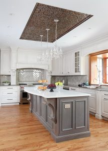 Tin ceiling detail in white kitchen with gray island