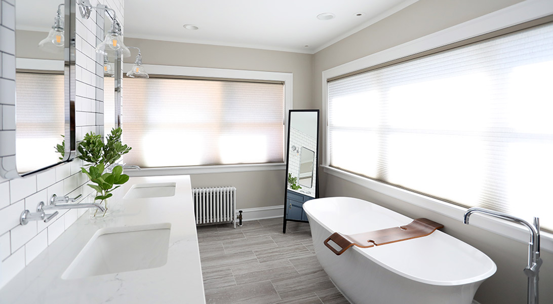 Master Bathroom with freestanding tub in front of large windows