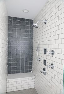 Shower with navy blue accent wall tile