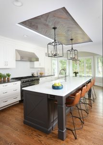 Painted kitchen with island and rustic wood ceiling