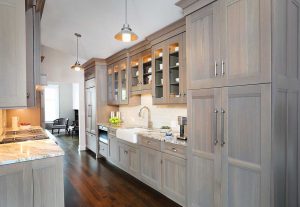 Gray washed wood stain cabinets in a galley kitchen