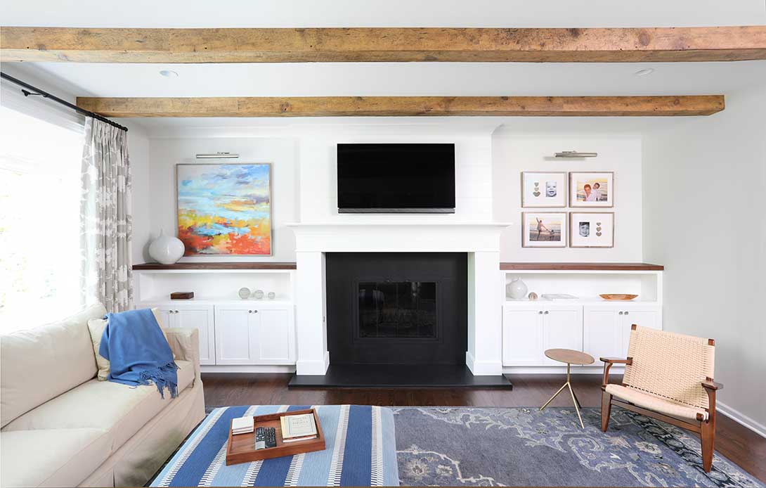 Family room with fireplace and wood beams on the ceiling