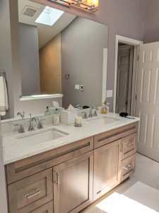 Double sink vanity, skylight, wood under cabinets