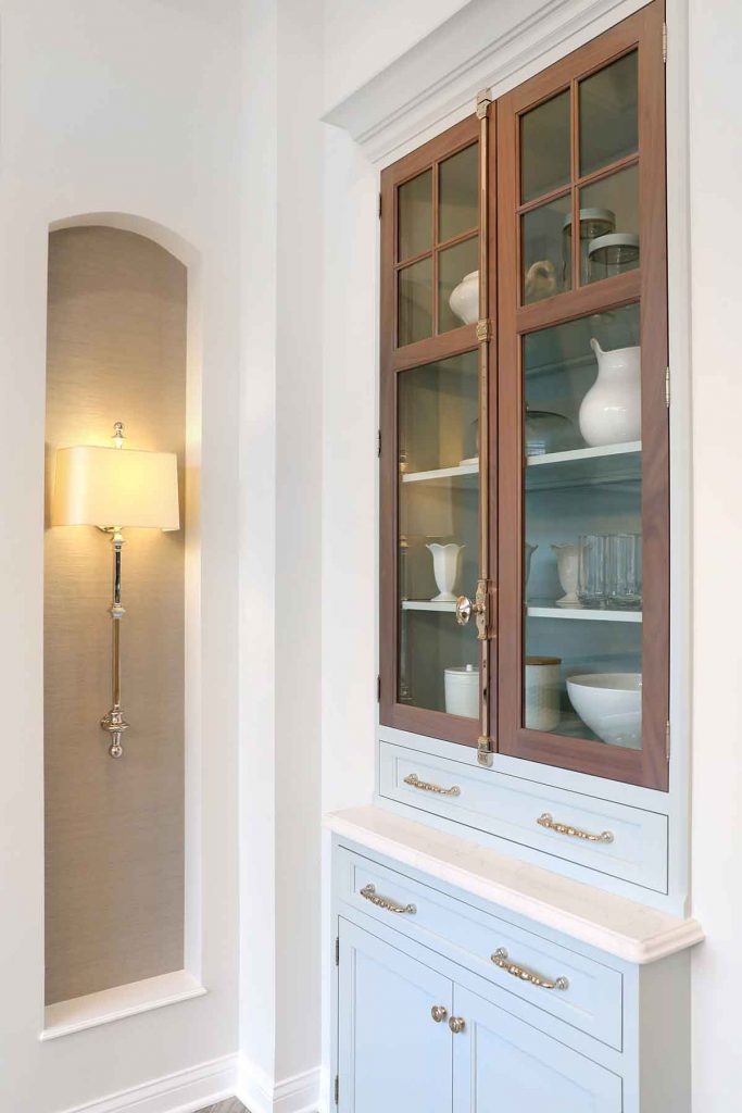 Pale blue kitchen cabinets with stained wood accents