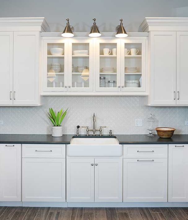 White kitchen with cabinets above the sink