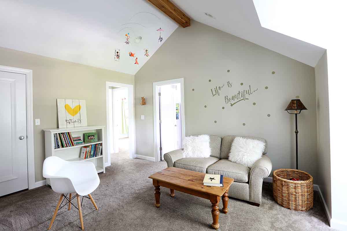 Playroom for two girls with a vaulted ceiling and rustic beam