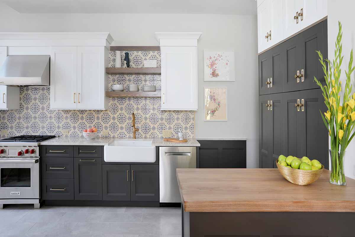 Gray and white cabinets, gold hardwarew, decorative backsplash